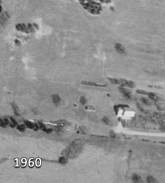 This series of aerial photographs shows Fort Hunt Elementary School from directly overhead in 1960, 1976, 1990, 1997, 2002, and 2015. The 1960 aerial is in black and white and shows the future site of the school. A farmhouse is on the future site of the parking lot and the building site is farm fields with scattered groupings of trees. The 1976 aerial shows the building after it has been repaired following the fire. It is about half the size of the building we know today. In 1990, the building looks identical to its 1976 configuration. The trees in front of the school have grown considerably. In 1997, two additional classroom spaces are visible. There was an addition to the front of the building near the main entrance, and a sizeable addition to the rear of the building at the northwest corner. In 2002, the renovation is in progress. The new library has been added to the front of the building and a new classroom section has been added to the rear of the building. Several trailers have been brought in to serve as classrooms on the south side of the building, and several construction trailers are visible behind the building. In 2015, the parking lot has been enlarged and the old main entrance walkway has been fully enclosed, and a new entrance and the new main office are visible. A large playground has been built behind the building.   